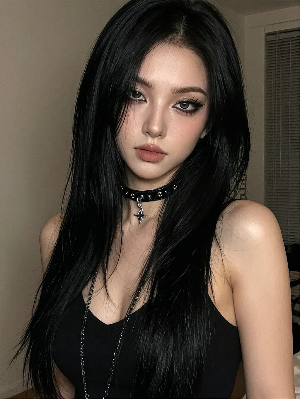 Fictional AI character with long black hair and a studded choker in a dim room